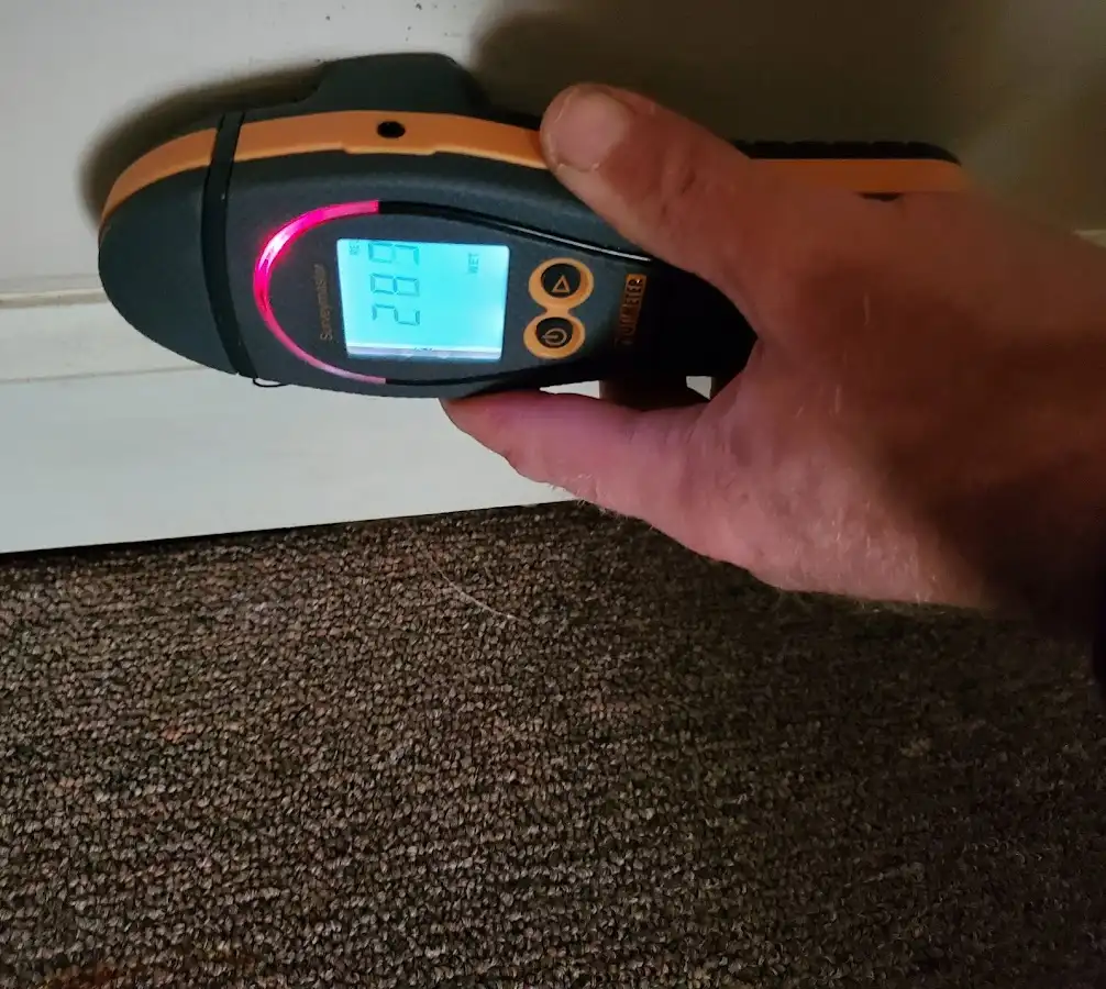 Moisture detection at baseboard during Storm Damage Restoration in Raceland